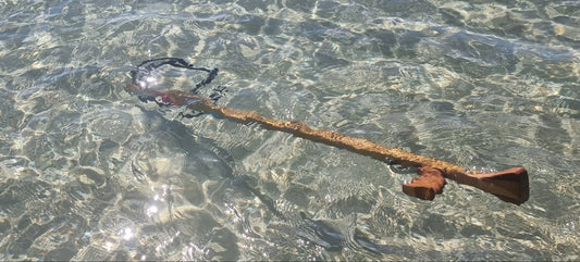 wooden speargun floating in sea